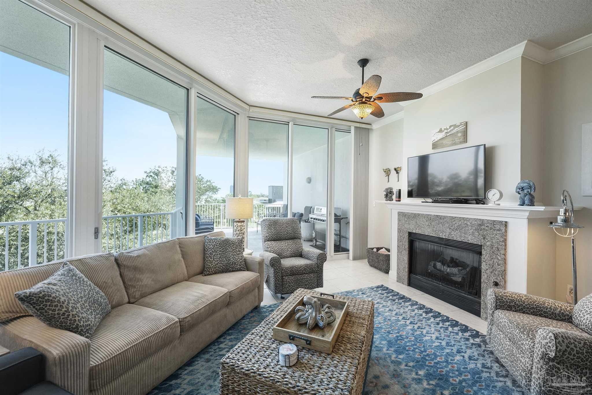 28250 Canal Road, Unit 205 Orange Beach, AL 36561 - Photo 5 of 60 a living room with furniture a fireplace and a flat screen tv