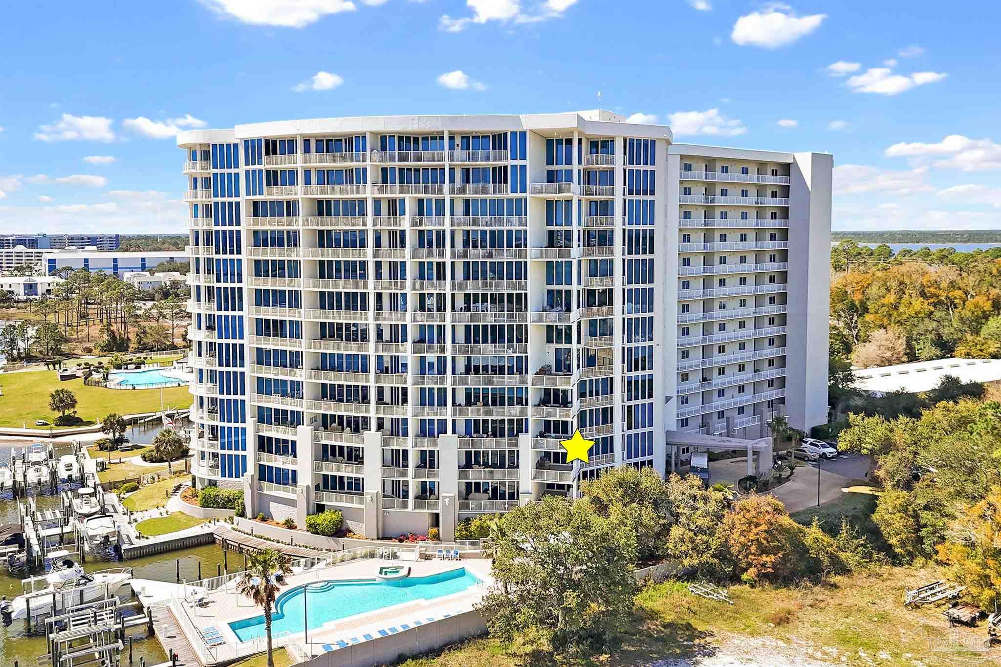 28250 Canal Road, Unit 205 Orange Beach, AL 36561 - Photo 57 of 60 a view of a balcony with a couple of cars parked in parking lot