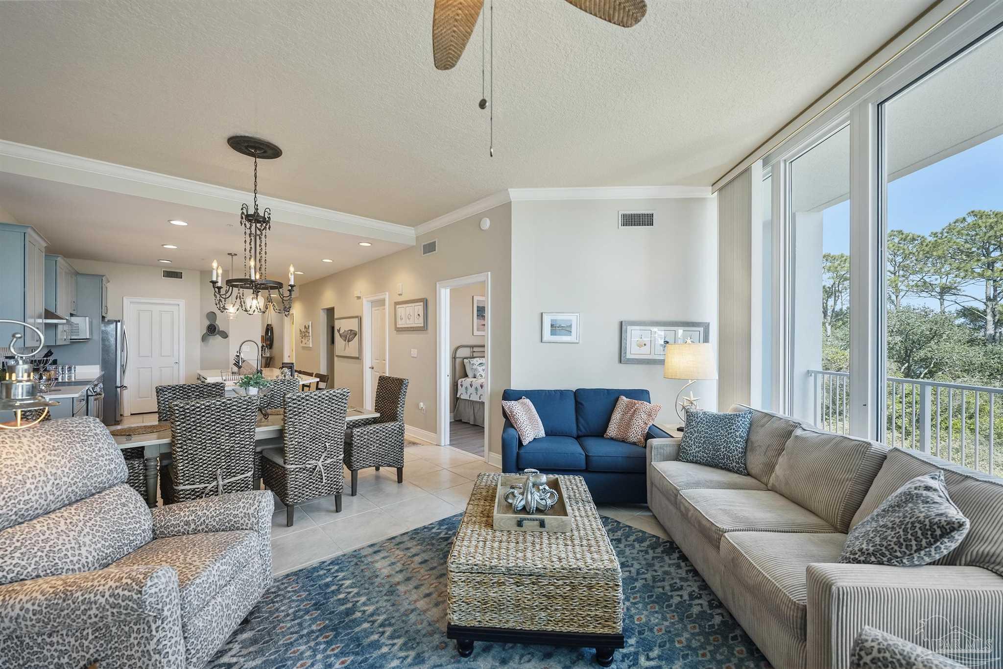 28250 Canal Road, Unit 205 Orange Beach, AL 36561 - Photo 10 of 60 a living room with furniture and a chandelier