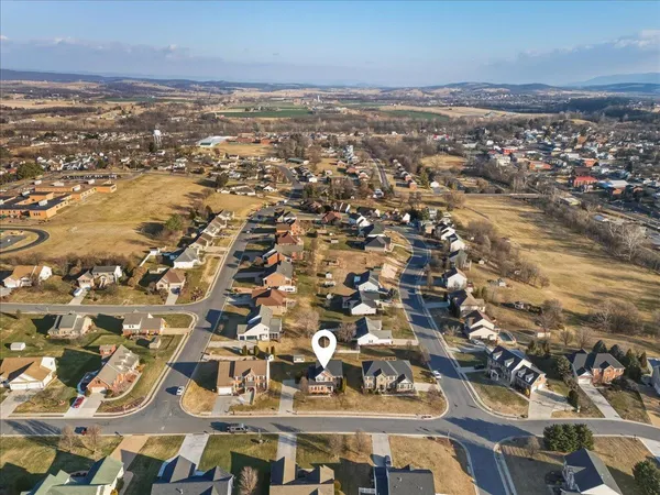 a view of house with backyard and outdoor seating