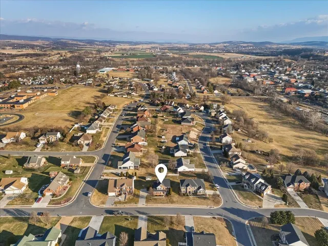 a view of house with backyard and outdoor seating