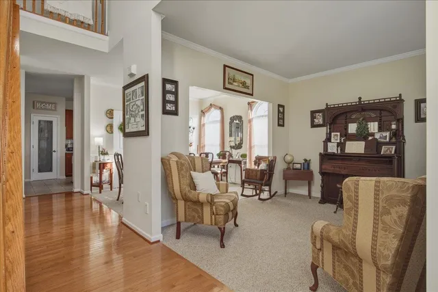 a living room with furniture and a chandelier