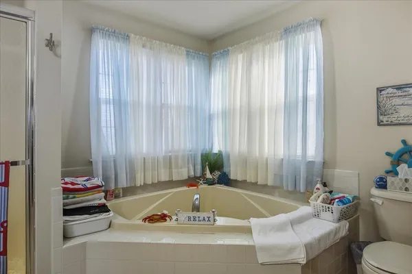 a bedroom with a bed and a large mirror