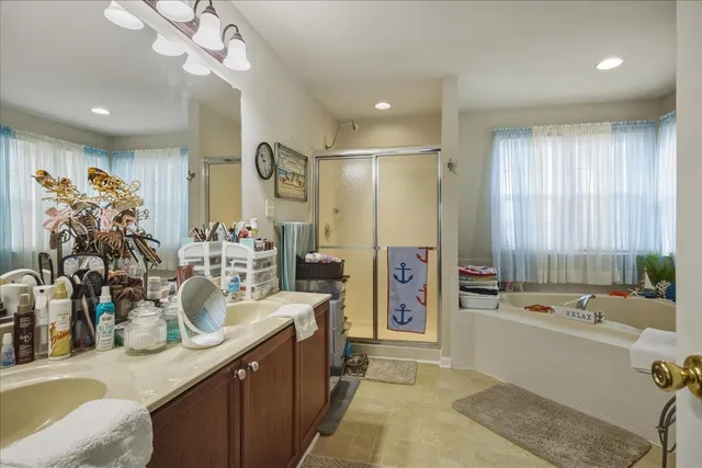 a spacious bedroom with a bed and a chandelier