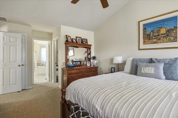 a view of a bedroom with wooden floor and a bathroom
