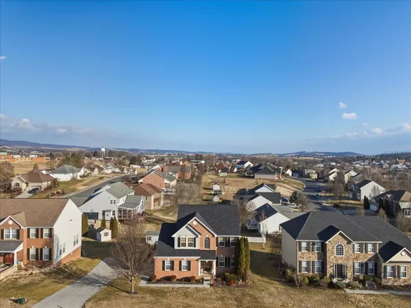 an aerial view of residential houses with city view