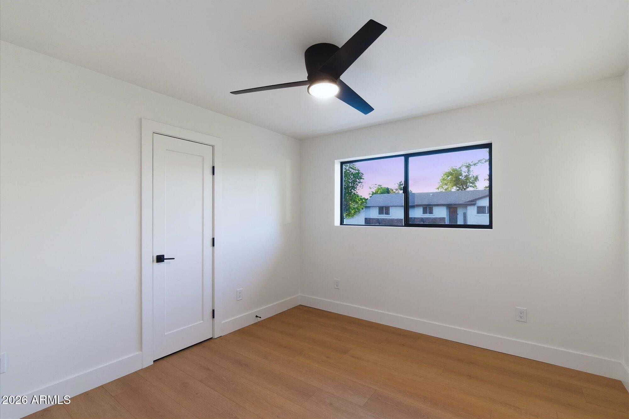 325 West Loma Lane Phoenix, AZ 85021 - Photo 17 of 30 an empty room with wooden floor and ceiling fan