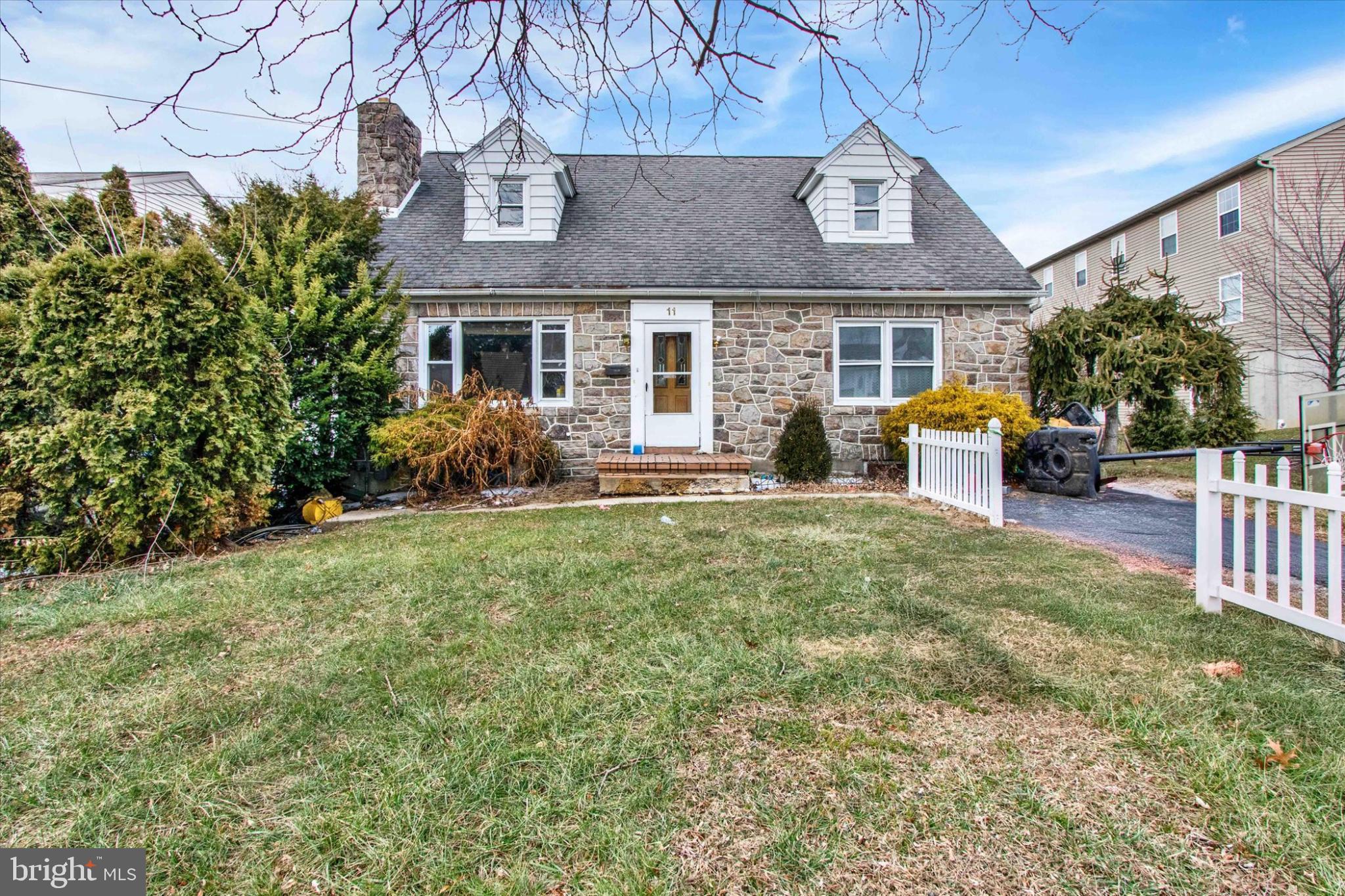 a front view of house with yard and outdoor seating