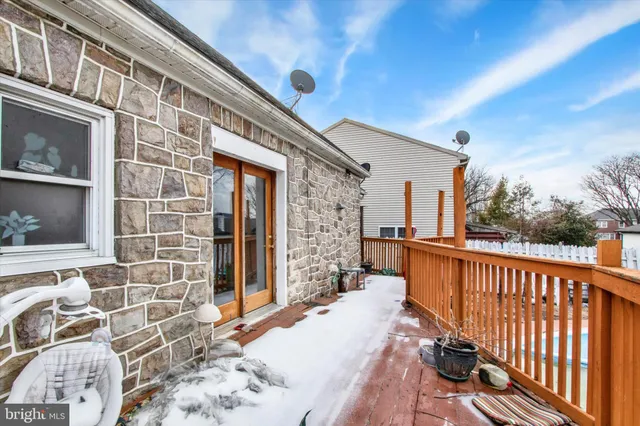a balcony with wooden floor and outdoor seating