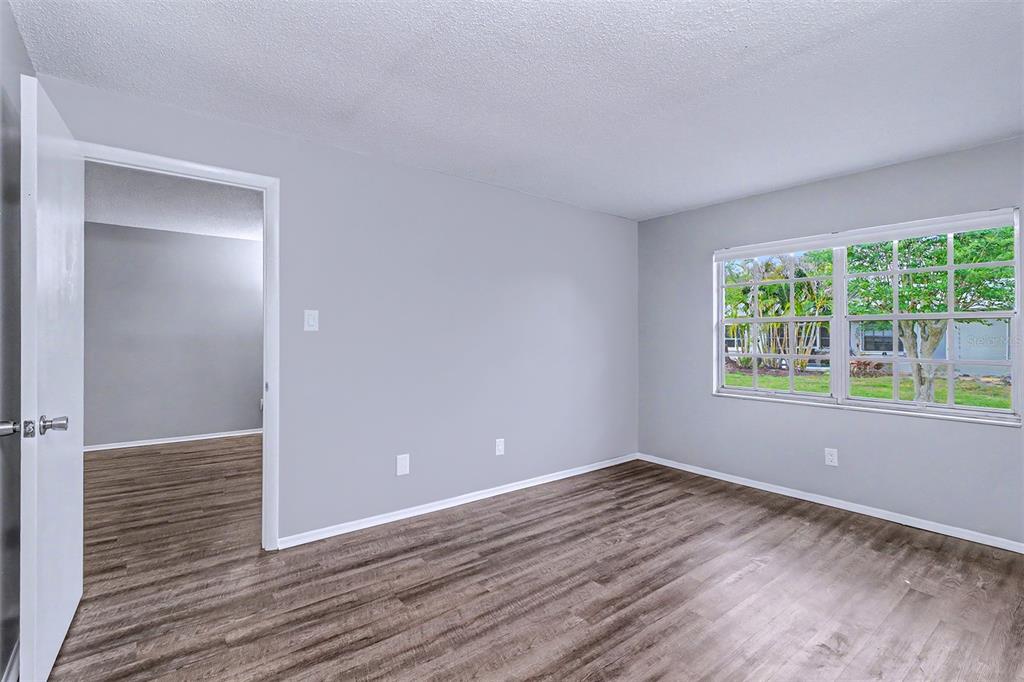 3661 Trophy Boulevard, Unit 3661 New Port Richey, FL 34655 - Photo 11 of 25 wooden floor in an empty room with a window