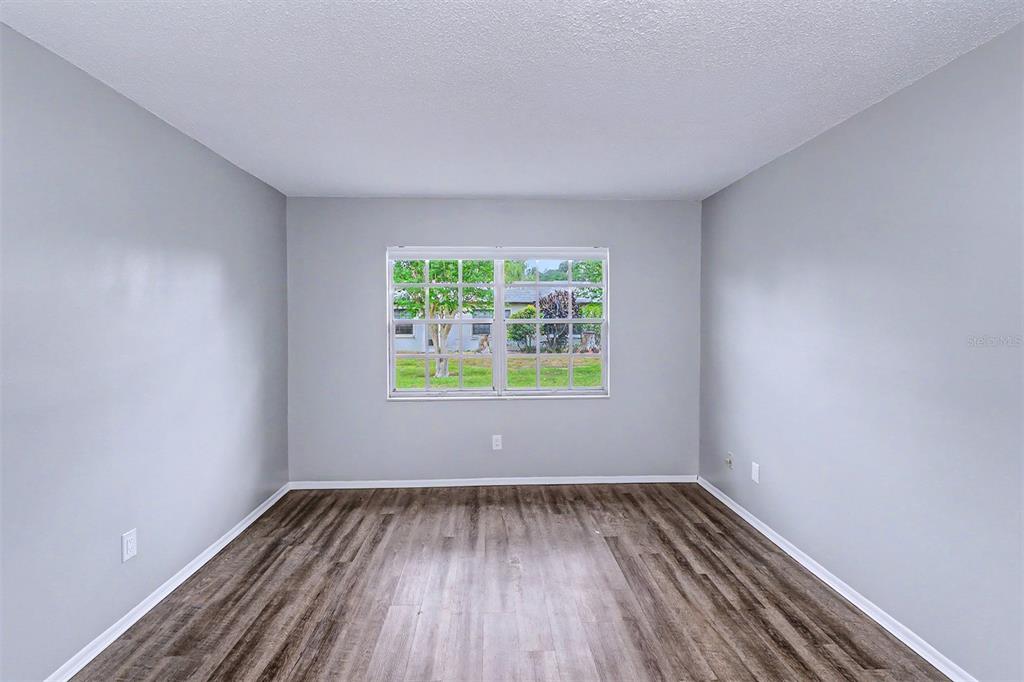 3661 Trophy Boulevard, Unit 3661 New Port Richey, FL 34655 - Photo 14 of 25 a view of an empty room with wooden floor and a window