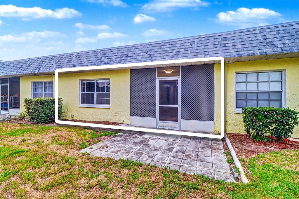3661 Trophy Boulevard, Unit 3661 New Port Richey, FL 34655 - Photo 19 of 25 a front view of a house with a yard