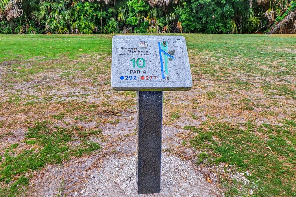 3661 Trophy Boulevard, Unit 3661 New Port Richey, FL 34655 - Photo 22 of 25 a sign broad on the side of the road