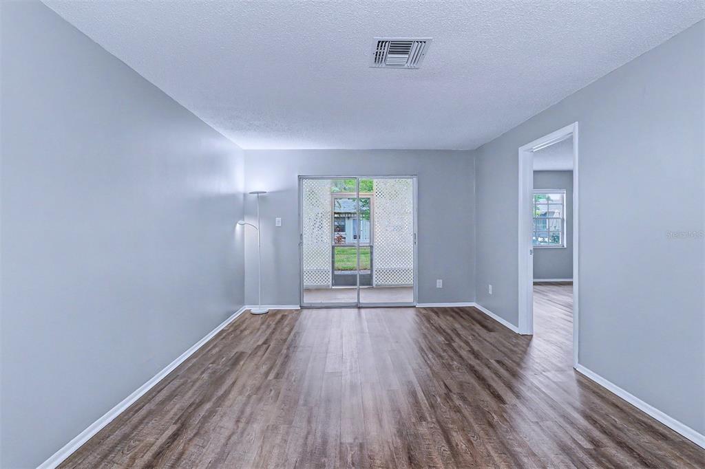 3661 Trophy Boulevard, Unit 3661 New Port Richey, FL 34655 - Photo 5 of 25 a view of wooden floor in an empty room with a window