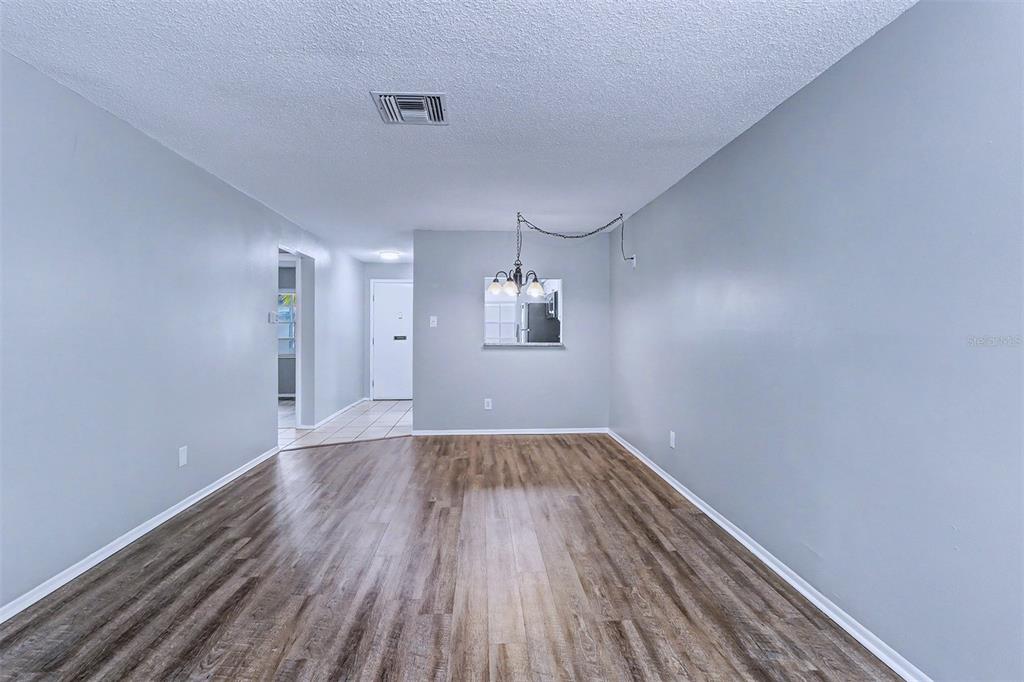 3661 Trophy Boulevard, Unit 3661 New Port Richey, FL 34655 - Photo 7 of 25 a view of an empty room with wooden floor and a window