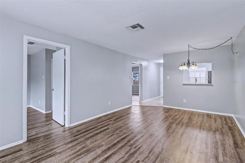 3661 Trophy Boulevard, Unit 3661 New Port Richey, FL 34655 - Photo 8 of 25 a view of an empty room with wooden floor and a window