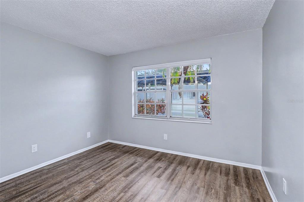 3661 Trophy Boulevard, Unit 3661 New Port Richey, FL 34655 - Photo 10 of 25 a view of an empty room with wooden floor and a window