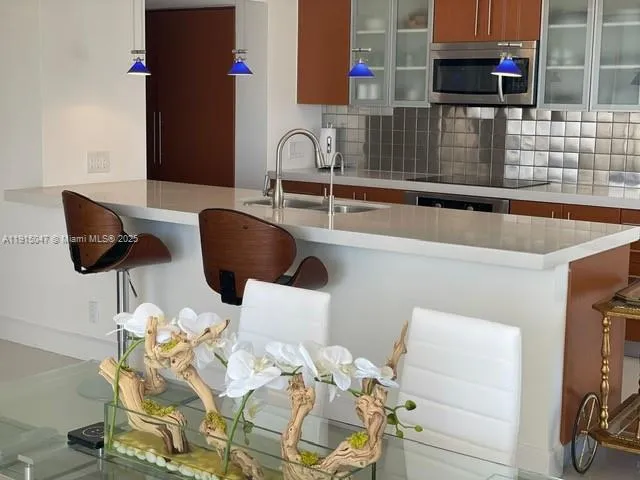 a kitchen with a sink and a refrigerator