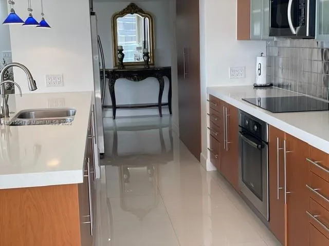 a kitchen with a refrigerator and a sink