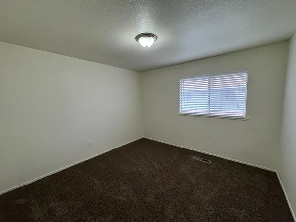 an empty room with a empty space and windows