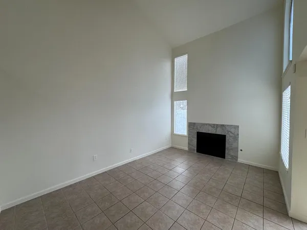 a view of an empty room with a fireplace