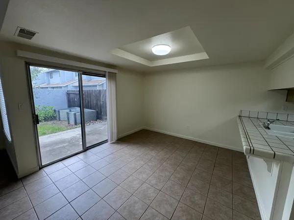 an empty room with sliding glass door and mountain view