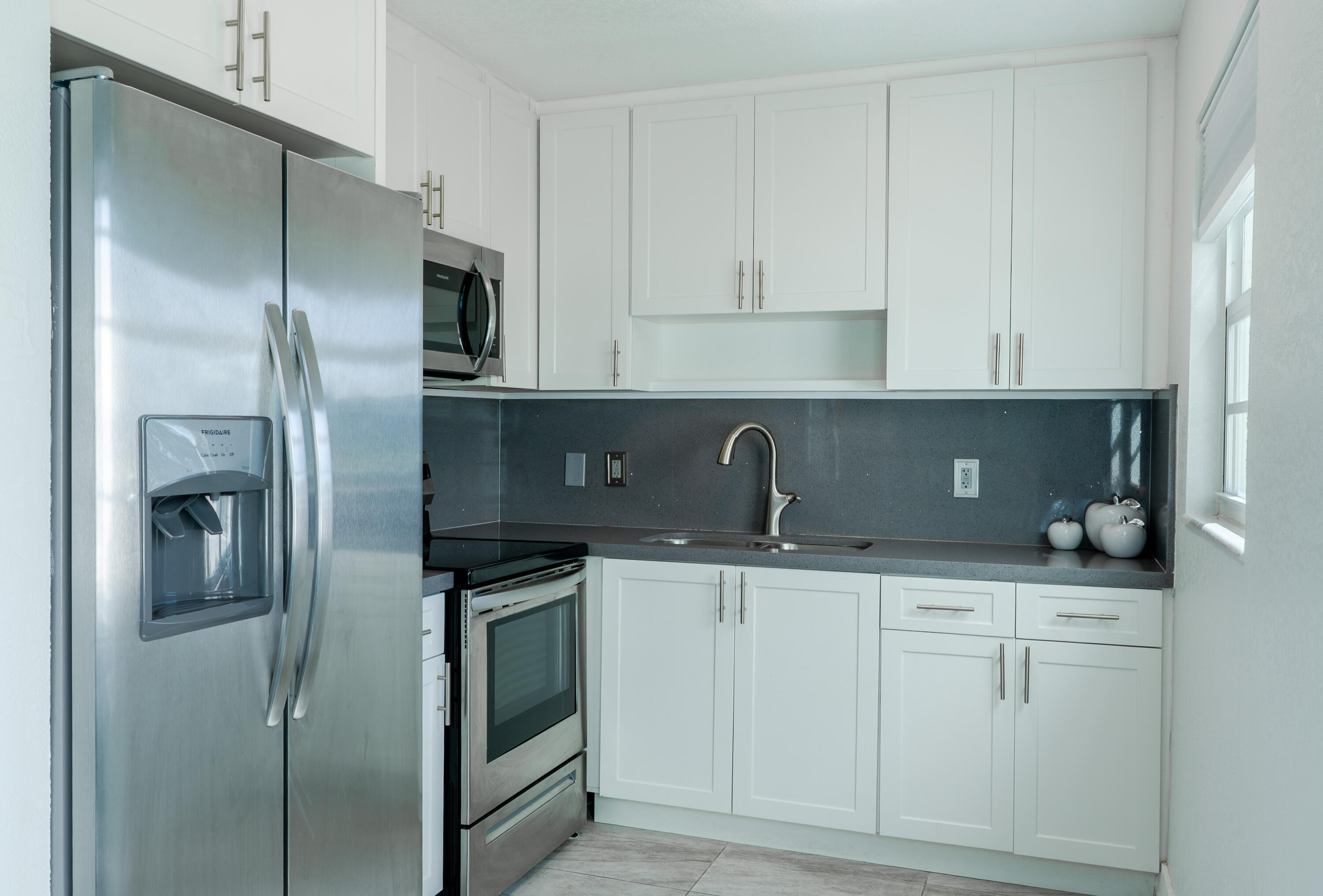 592 Fanshaw O Boca Raton, FL 33434 - Photo 4 of 26 a kitchen with stainless steel appliances granite countertop a refrigerator and a sink