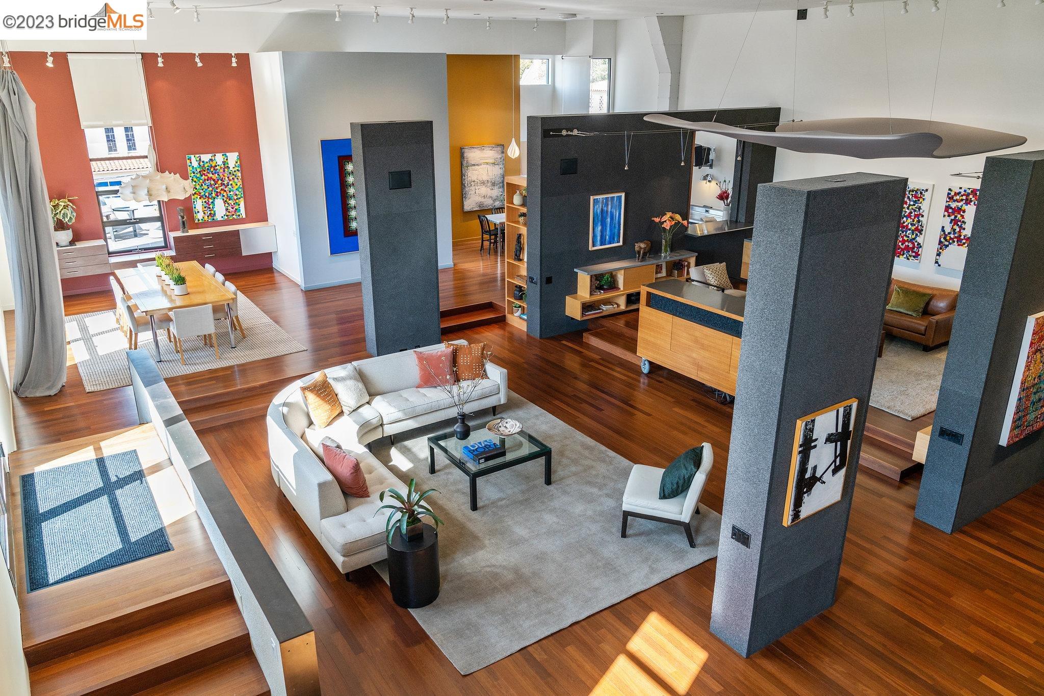 a living room with furniture a flat screen tv and a table