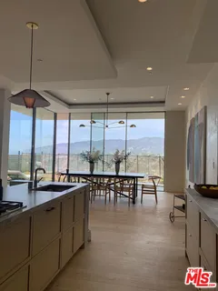 a living room with furniture and painting on the wall