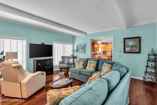 a living room with furniture flat screen tv and a fireplace