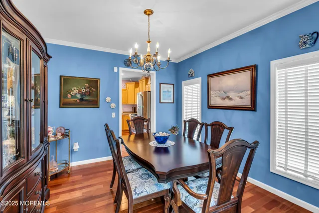 a view of a dining room with furniture wooden floor and a chandelier