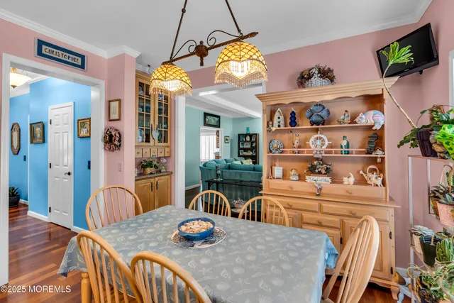 a view of a dining room with furniture and a chandelier