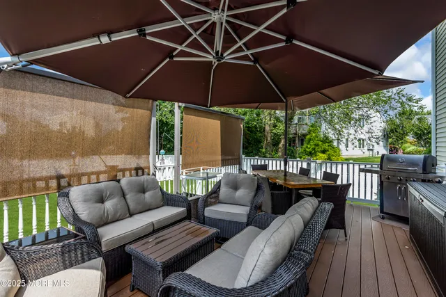 a patio with patio a table and chairs under an umbrella