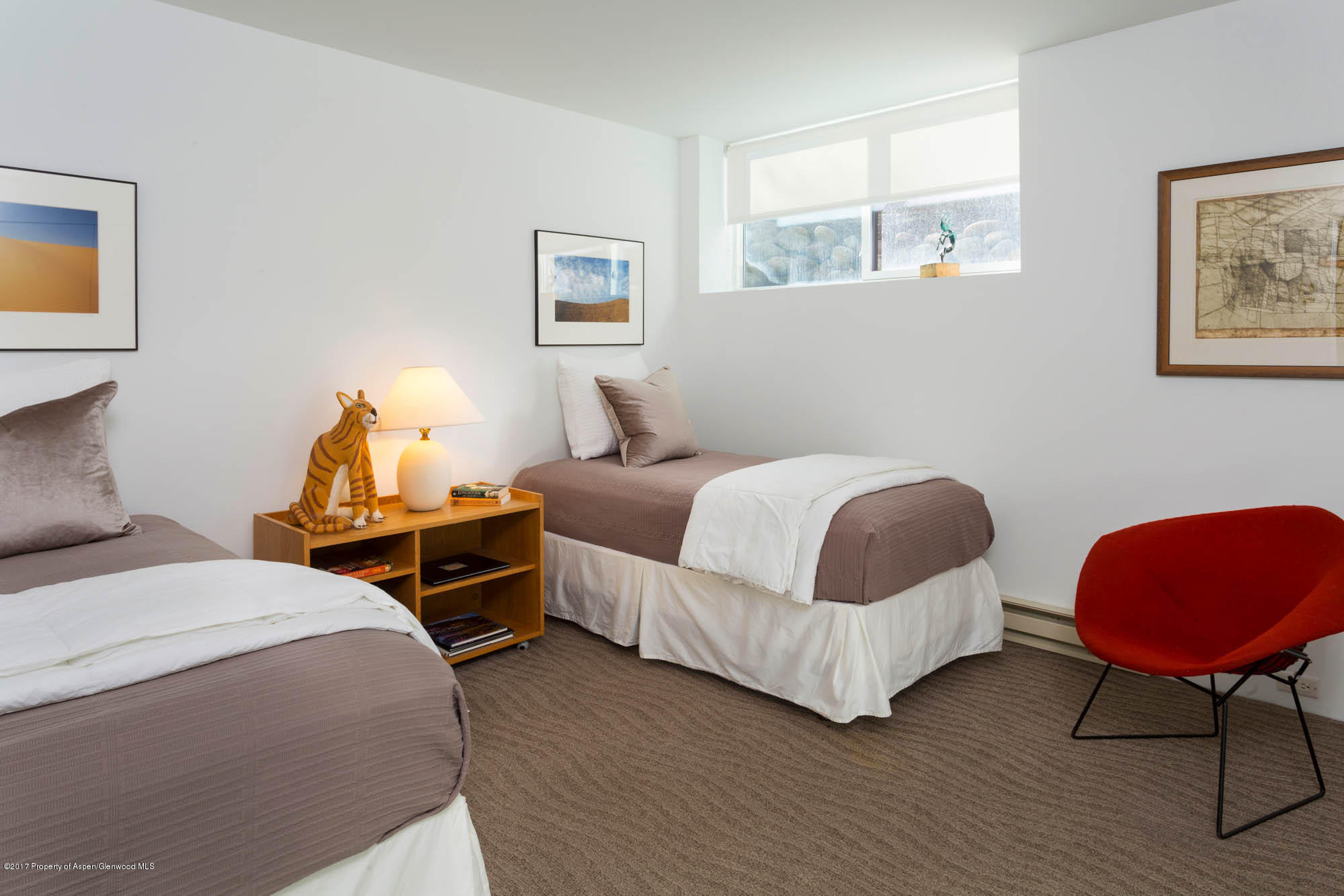 61 Oak Ridge Road Snowmass Village, CO 81615 - Photo 22 of 35 a bedroom with a bed a lamp potted plant and a window