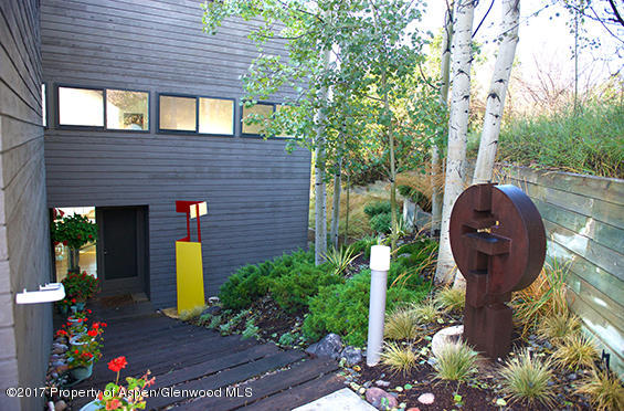 61 Oak Ridge Road Snowmass Village, CO 81615 - Photo 29 of 35 a front view of a house with garden
