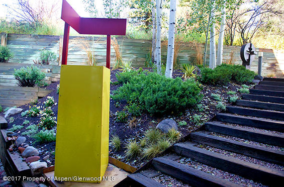 61 Oak Ridge Road Snowmass Village, CO 81615 - Photo 30 of 35 a view of a backyard with plants and a bench