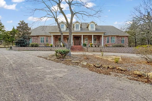 a front view of a house with garden and patio