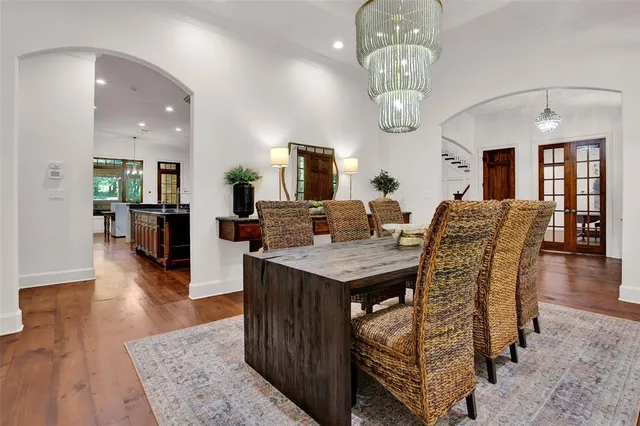a view of a dining room with furniture wooden floor and chandelier