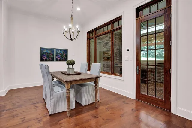 a view of a dining room with furniture wooden floor and chandelier
