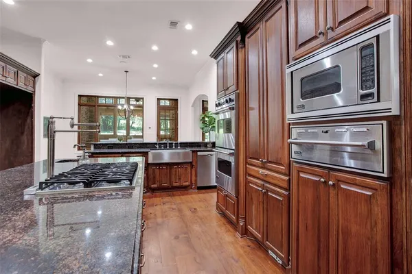 a kitchen with stainless steel appliances granite countertop a stove and a refrigerator