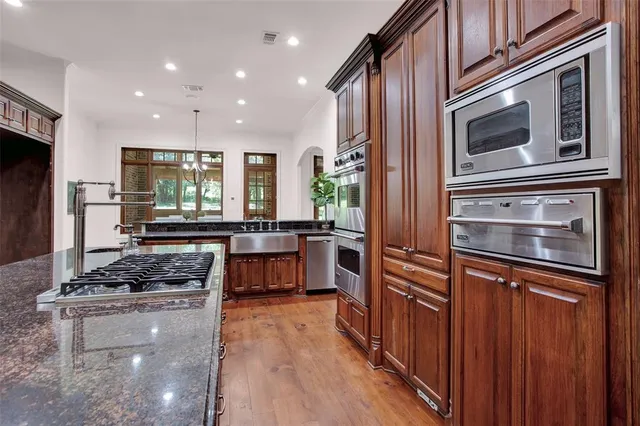 a kitchen with stainless steel appliances granite countertop a stove and a refrigerator