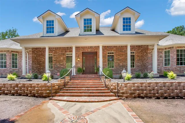 a front view of a house with porch and glass windows