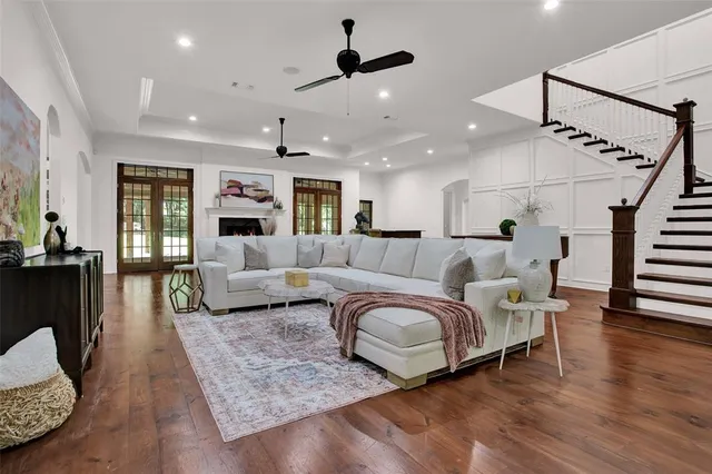 a living room with furniture and a ceiling fan