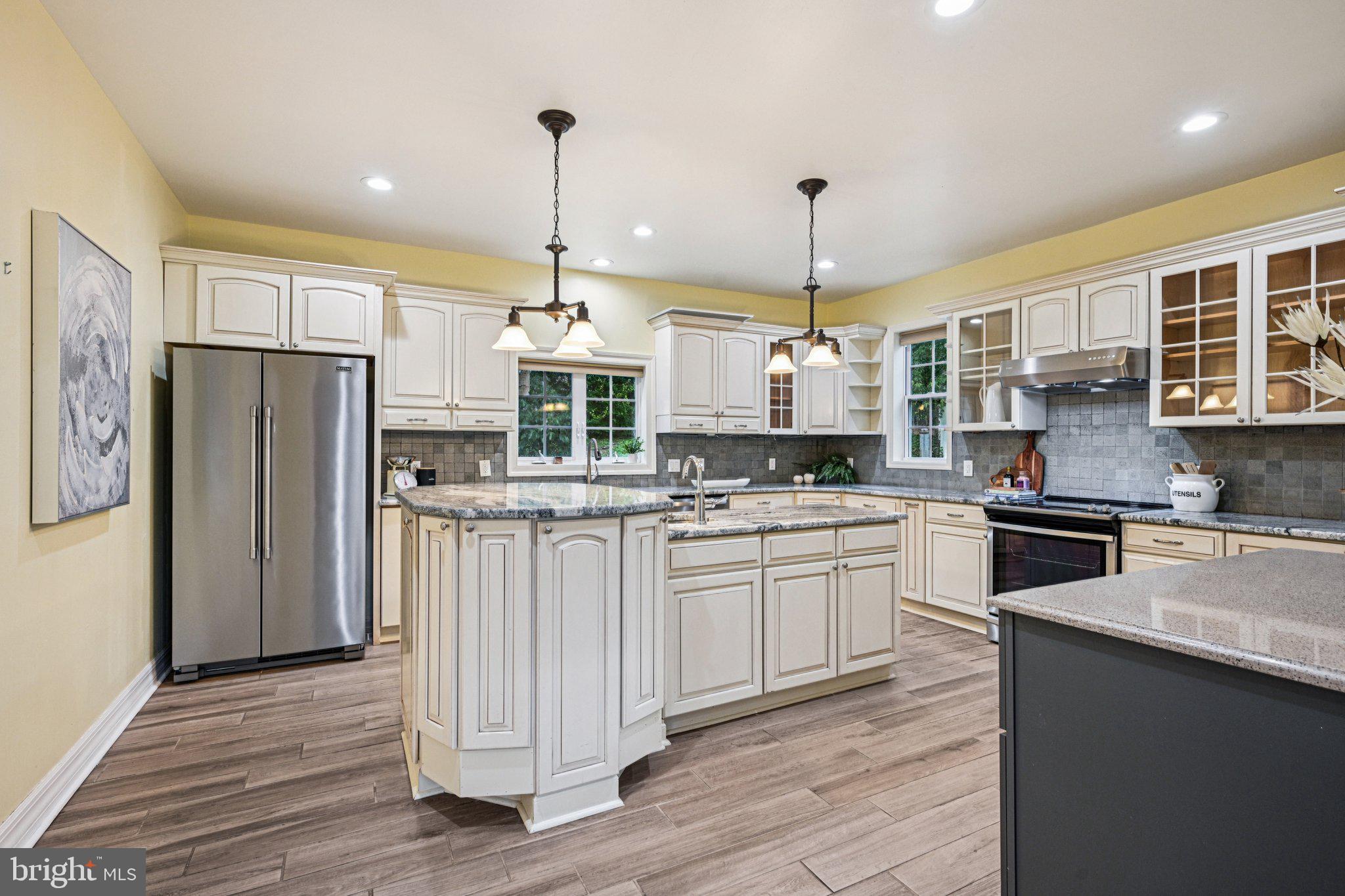 700 South Roberts Road Bryn Mawr, PA 19010 - Photo 12 of 42 a kitchen with stainless steel appliances granite countertop a refrigerator a stove a sink dishwasher a oven and a dining table with wooden floor