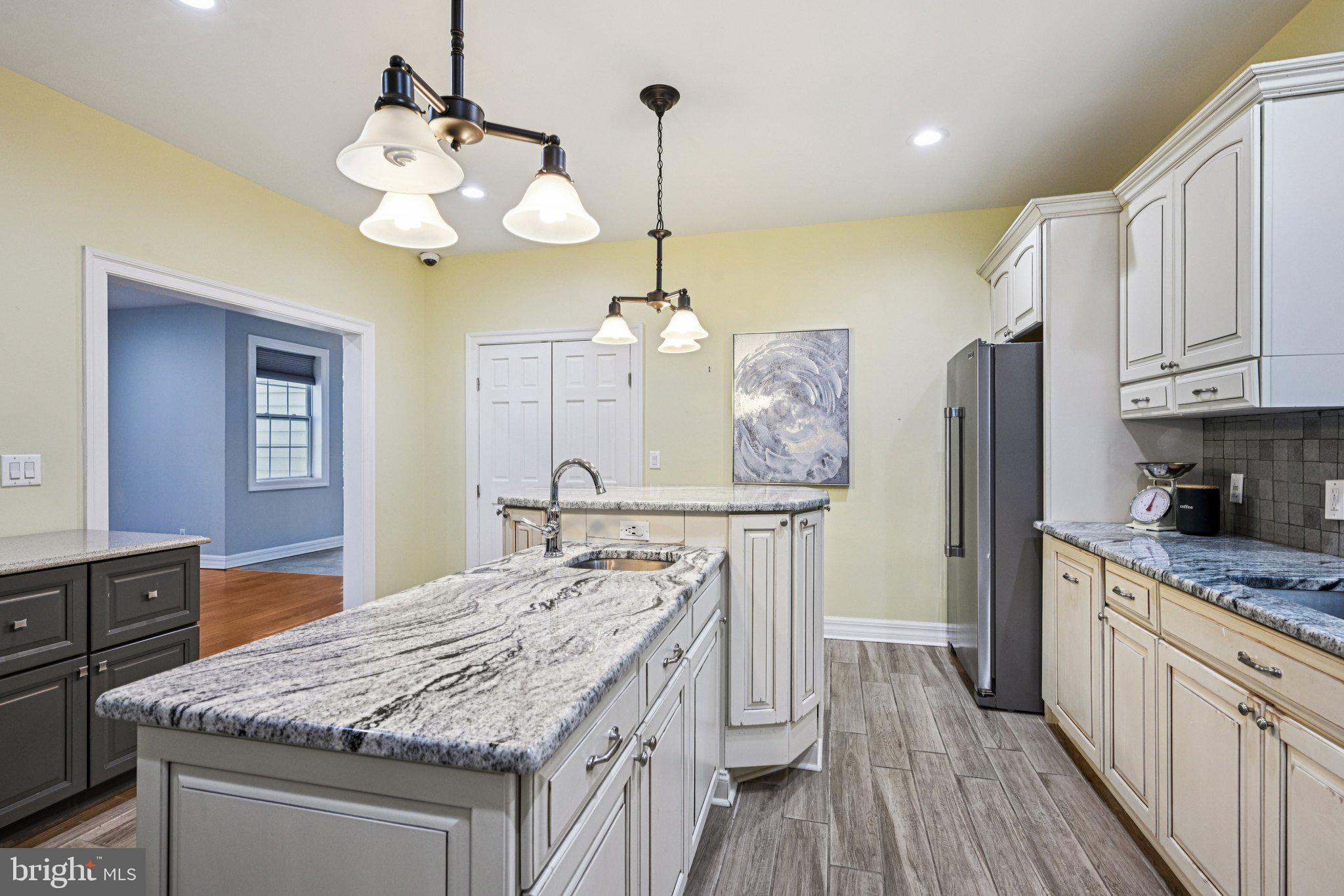 700 South Roberts Road Bryn Mawr, PA 19010 - Photo 14 of 42 a kitchen with kitchen island granite countertop wooden cabinets and refrigerator