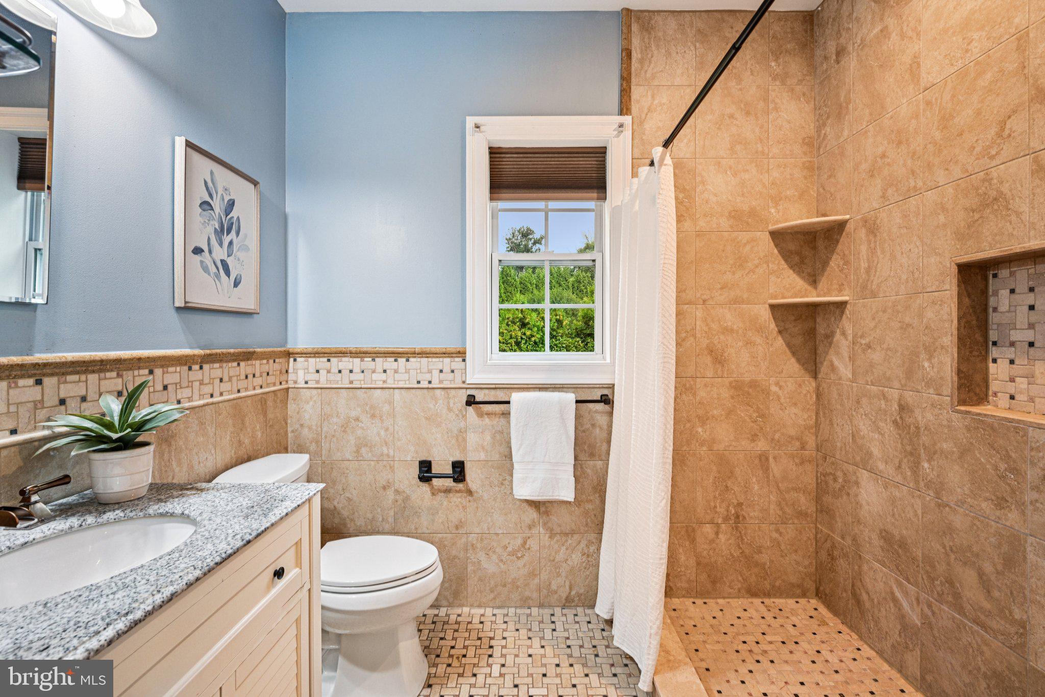 700 South Roberts Road Bryn Mawr, PA 19010 - Photo 23 of 42 a bathroom with a granite countertop toilet a sink and a mirror