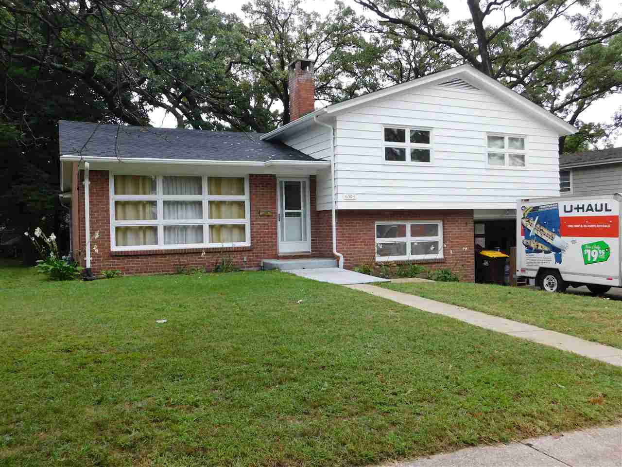 6309 Park Ridge Road Loves Park, IL 61111 - Photo 1 of 26 a front view of a house with a garden and yard