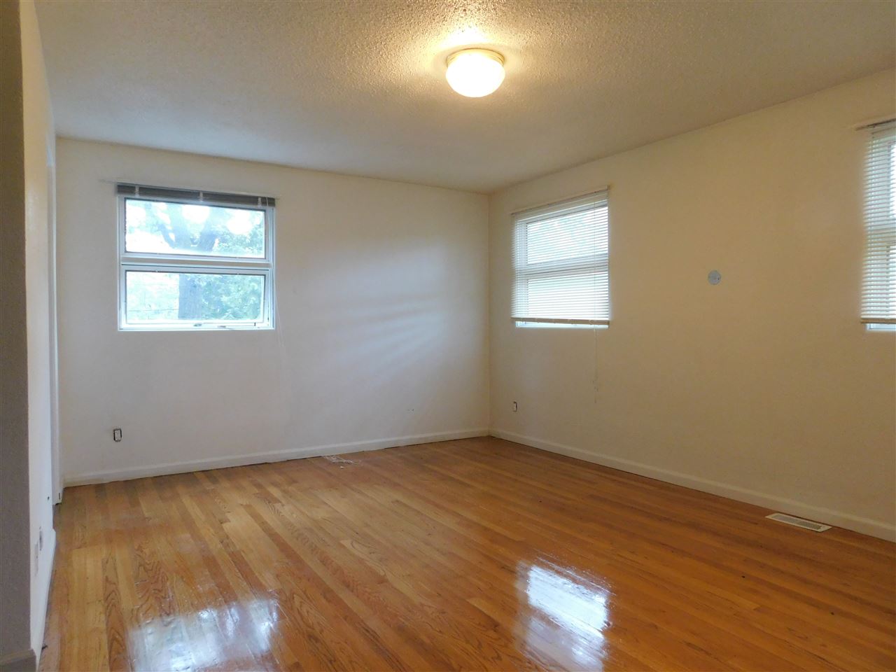6309 Park Ridge Road Loves Park, IL 61111 - Photo 11 of 26 a view of an empty room with wooden floor and a window
