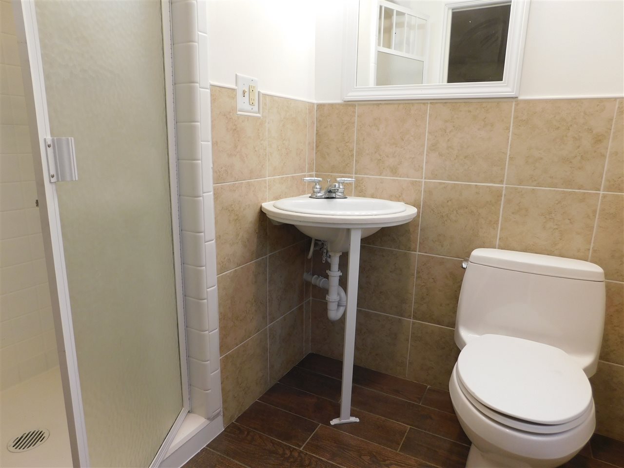 6309 Park Ridge Road Loves Park, IL 61111 - Photo 13 of 26 a white toilet sitting next to a bathroom sink