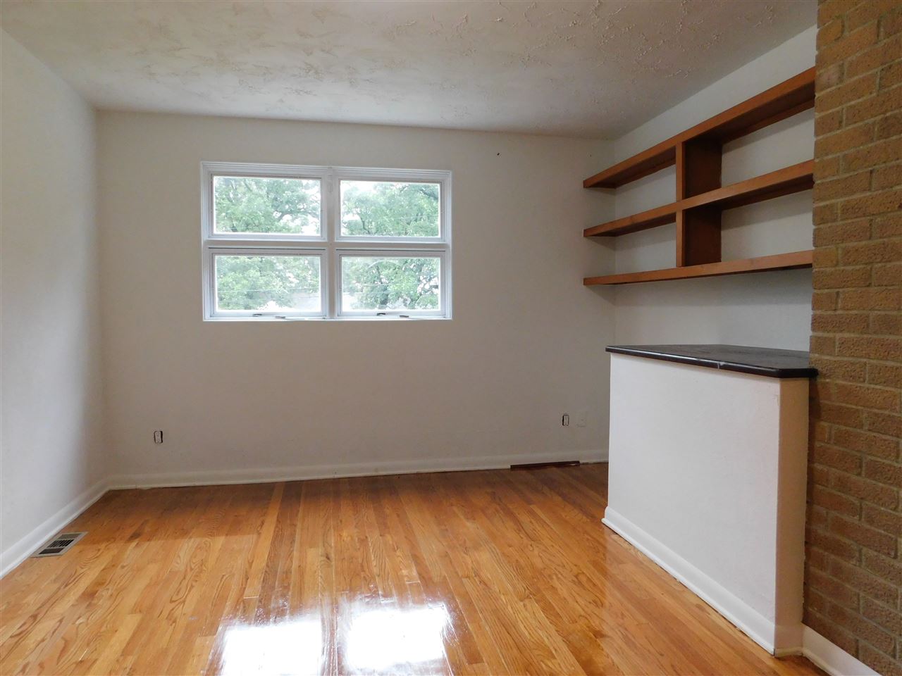 6309 Park Ridge Road Loves Park, IL 61111 - Photo 16 of 26 an empty room with wooden floor and windows